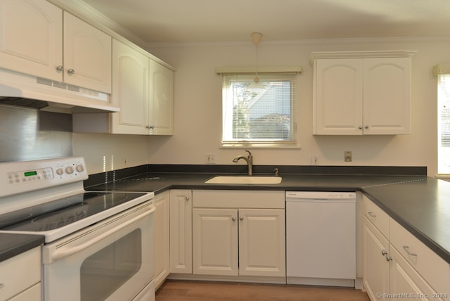 kitchen featuring white cabinetry, a wealth of natural light, sink, and white appliances