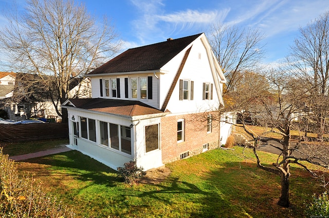 exterior space featuring a lawn and a sunroom