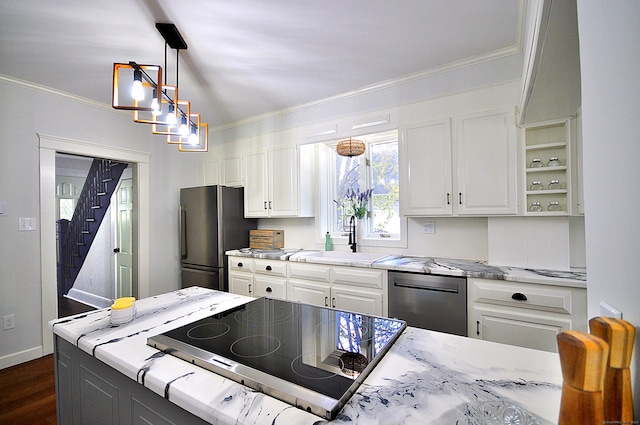 kitchen with dark wood-type flooring, sink, ornamental molding, appliances with stainless steel finishes, and white cabinetry