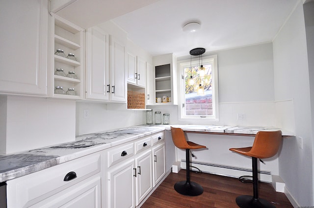 kitchen with pendant lighting, light stone counters, a baseboard radiator, dark hardwood / wood-style flooring, and white cabinetry