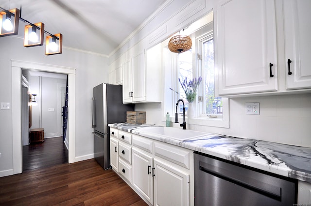 kitchen with a wealth of natural light, white cabinets, dark wood-type flooring, and appliances with stainless steel finishes