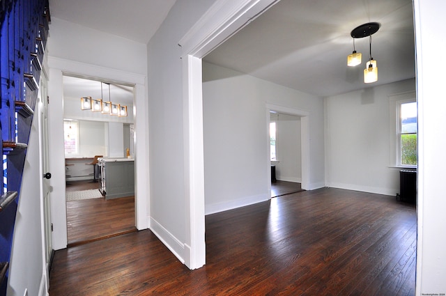 interior space with dark hardwood / wood-style flooring and baseboard heating