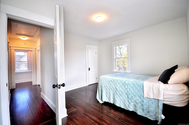 bedroom with dark hardwood / wood-style flooring