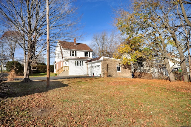 exterior space with a lawn and a garage