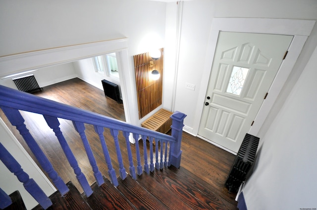 stairway with hardwood / wood-style floors