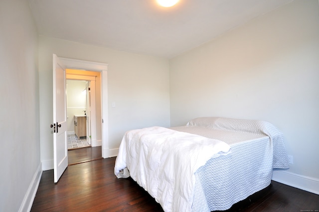 bedroom with dark hardwood / wood-style floors