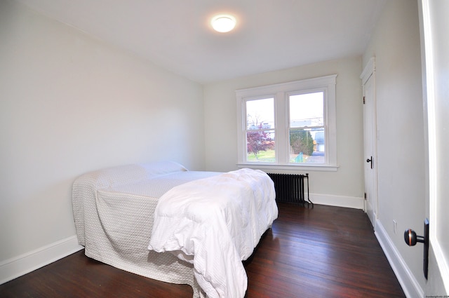 bedroom featuring radiator and dark wood-type flooring