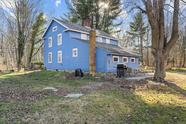 view of side of property with a patio area