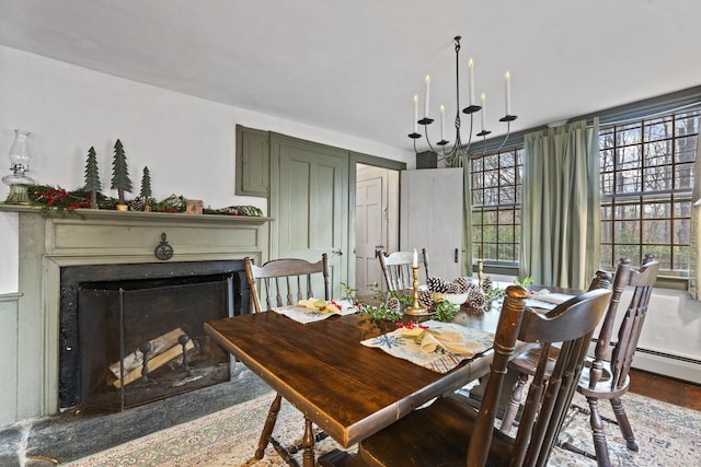 dining area featuring hardwood / wood-style floors and a notable chandelier