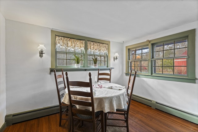 dining space with baseboard heating and dark hardwood / wood-style floors