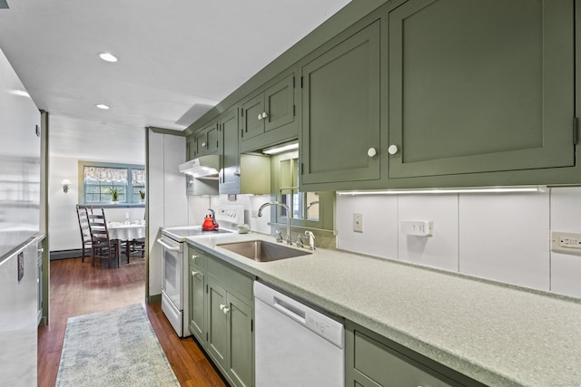 kitchen featuring white appliances, plenty of natural light, green cabinets, and sink