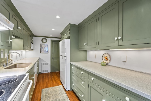 kitchen with green cabinets, sink, dark hardwood / wood-style flooring, and white refrigerator