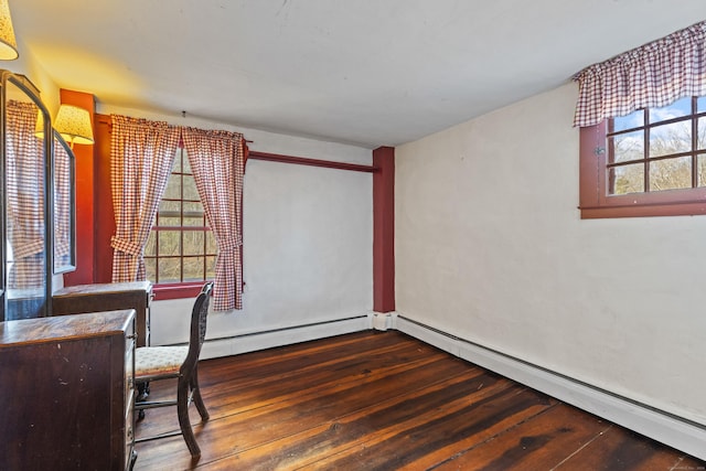 office area with dark hardwood / wood-style floors and baseboard heating