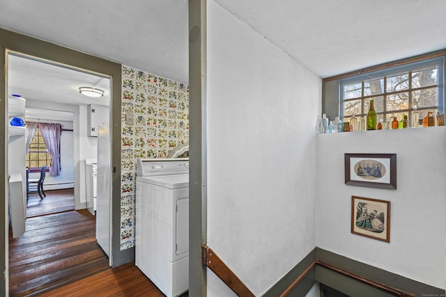 washroom featuring washer / clothes dryer, a wealth of natural light, dark hardwood / wood-style floors, and a baseboard heating unit