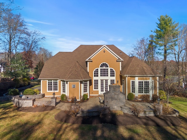 view of property with a front lawn, a patio, and french doors