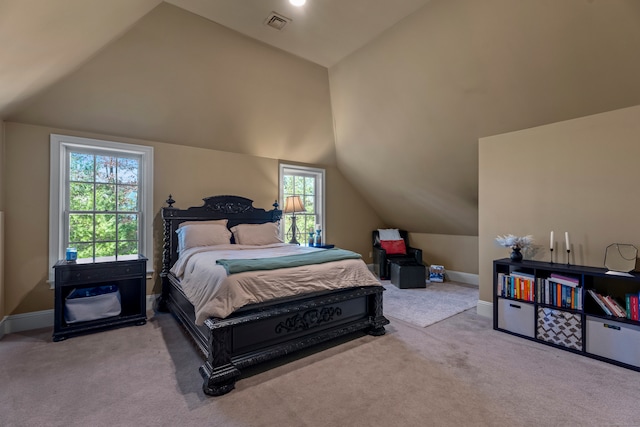 bedroom featuring multiple windows, light carpet, and vaulted ceiling