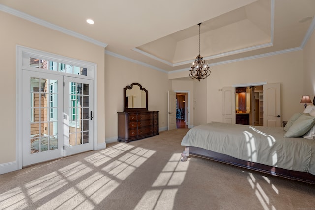 carpeted bedroom featuring french doors, crown molding, and a tray ceiling