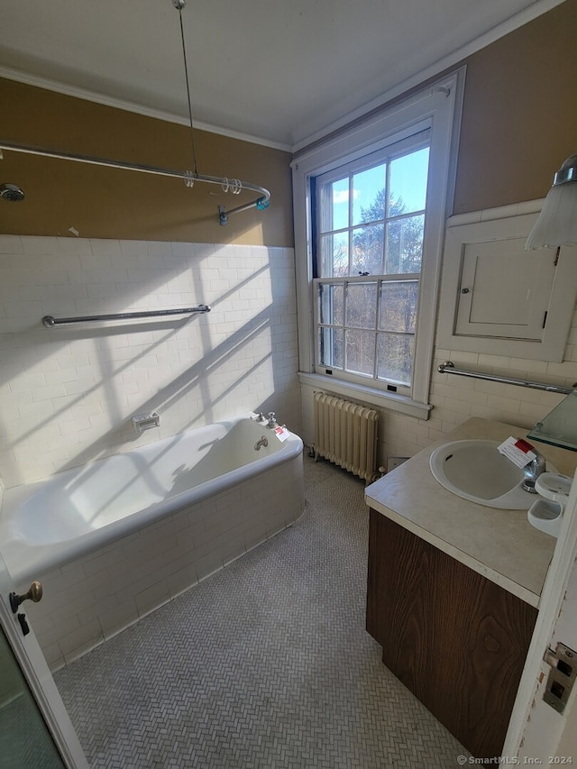 bathroom featuring bathing tub / shower combination, radiator, vanity, and ornamental molding