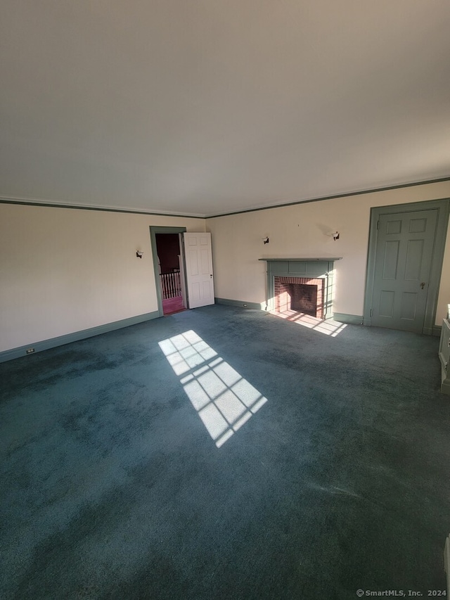 unfurnished living room with carpet floors and a brick fireplace