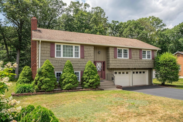 45 Wentworth Dr, East Hartford, CT 06118 - raised ranch with a chimney, asphalt driveway, an attached garage, and a front lawn