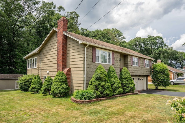 45 Wentworth Dr, East Hartford, CT 06118 - split foyer home with a chimney, asphalt driveway, a garage, and a front lawn
