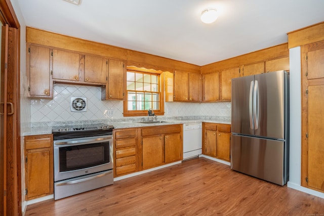 45 Wentworth Dr, East Hartford, CT 06118 - kitchen featuring stainless steel appliances, brown cabinets, light countertops, and tasteful backsplash