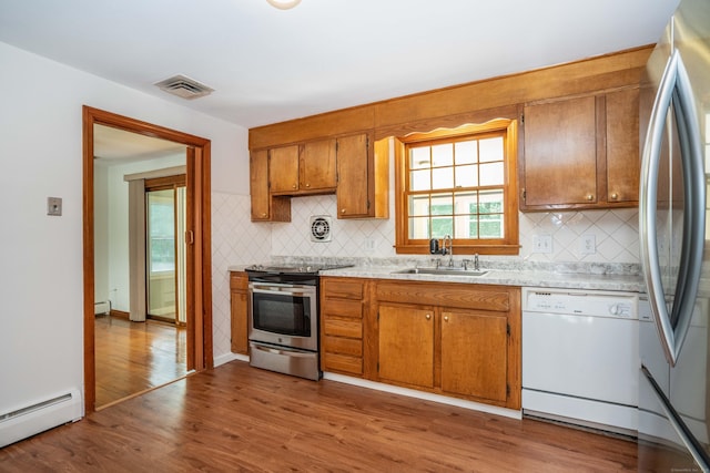 45 Wentworth Dr, East Hartford, CT 06118 - kitchen with appliances with stainless steel finishes, a baseboard radiator, brown cabinets, light countertops, and wood finished floors