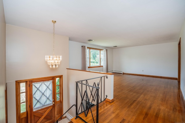45 Wentworth Dr, East Hartford, CT 06118 - foyer featuring baseboard heating, light wood-type flooring, and a chandelier