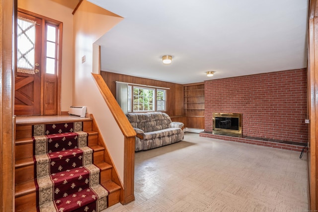 45 Wentworth Dr, East Hartford, CT 06118 - living room featuring baseboard heating, built in shelves, a brick fireplace, and stairway