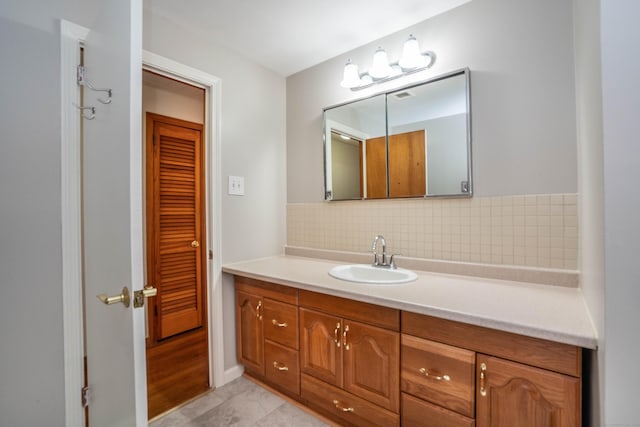 45 Wentworth Dr, East Hartford, CT 06118 - bathroom with vanity, decorative backsplash, and tile patterned flooring