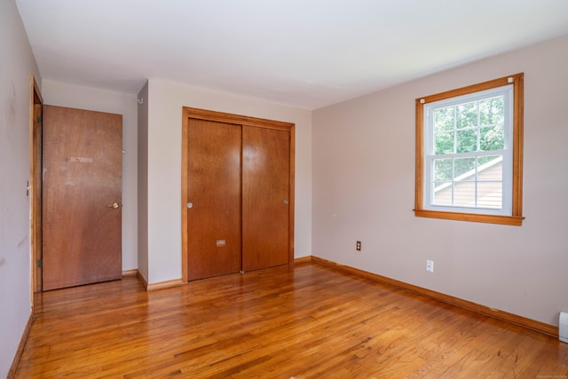 45 Wentworth Dr, East Hartford, CT 06118 - unfurnished bedroom with light wood-type flooring, a closet, and baseboard heating