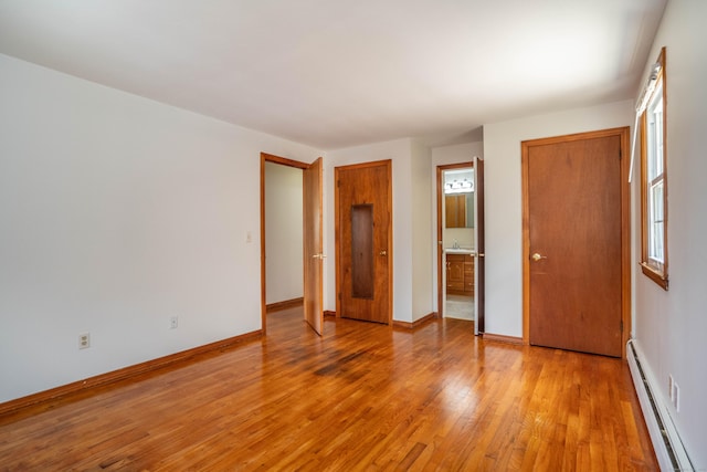 45 Wentworth Dr, East Hartford, CT 06118 - unfurnished bedroom featuring baseboard heating, light wood-style flooring, and multiple closets