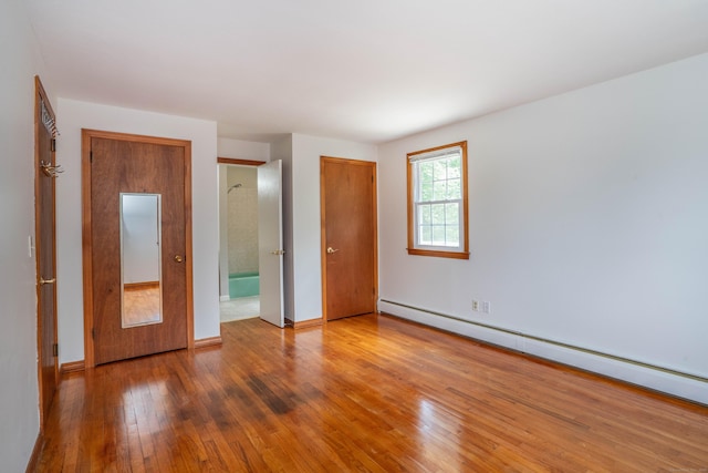 45 Wentworth Dr, East Hartford, CT 06118 - unfurnished bedroom featuring a baseboard heating unit and hardwood / wood-style floors