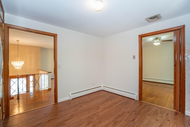 45 Wentworth Dr, East Hartford, CT 06118 - spare room featuring baseboard heating, a chandelier, and wood finished floors