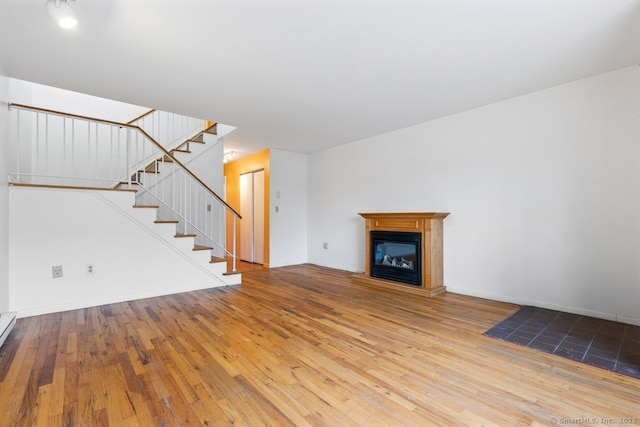 unfurnished living room featuring hardwood / wood-style flooring