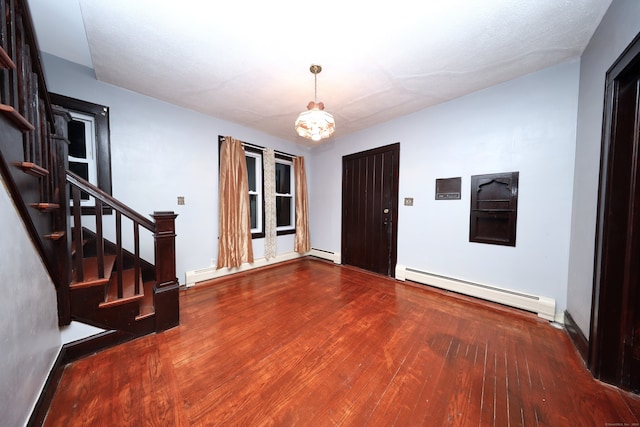 foyer featuring dark hardwood / wood-style floors and baseboard heating