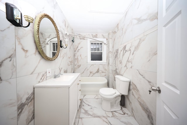 bathroom with vanity, toilet, and tile walls