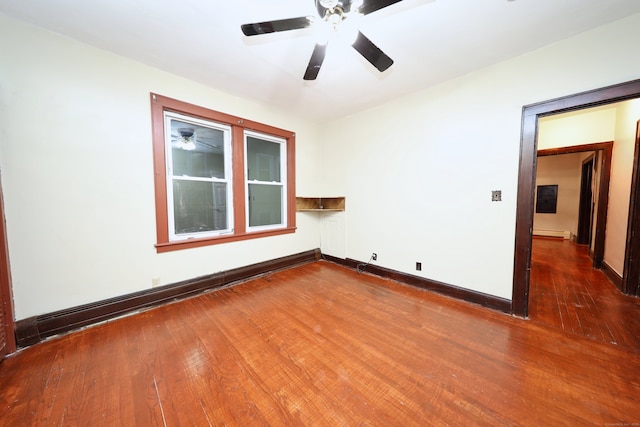 unfurnished room featuring hardwood / wood-style flooring, ceiling fan, and a baseboard heating unit