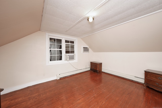 bonus room with a textured ceiling, baseboard heating, and hardwood / wood-style flooring