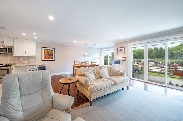 living room featuring light hardwood / wood-style flooring and ornamental molding