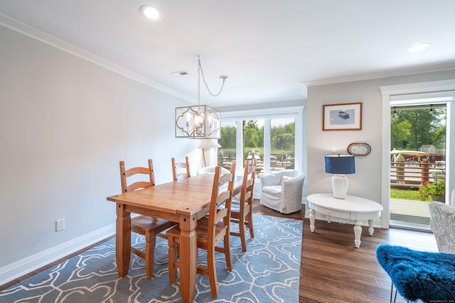 dining space featuring a notable chandelier, crown molding, and dark hardwood / wood-style floors