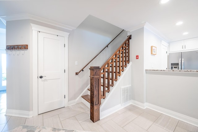 stairs featuring tile patterned floors and ornamental molding