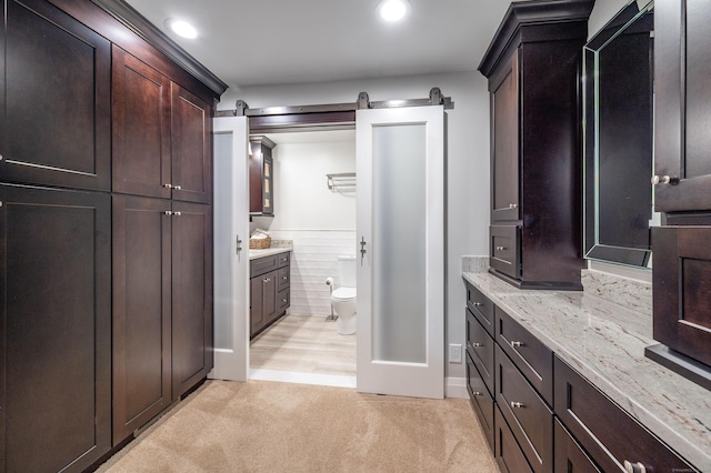 bathroom featuring toilet and vanity