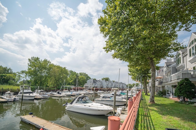 dock area featuring a water view and a lawn