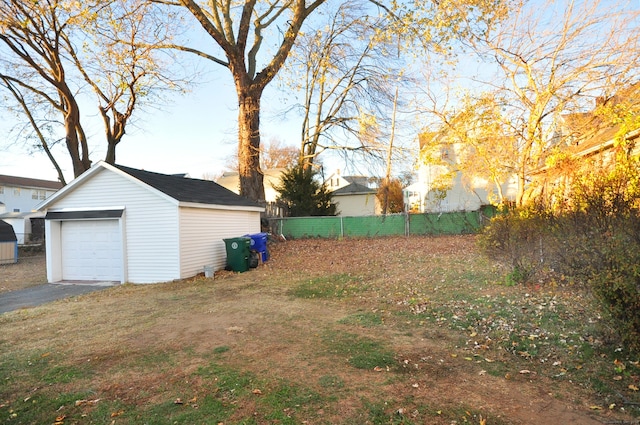 view of yard with a garage and an outdoor structure