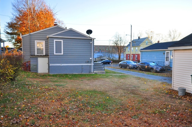 view of side of home with a yard