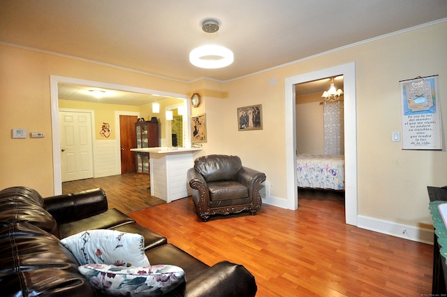 living room with hardwood / wood-style floors and ornamental molding