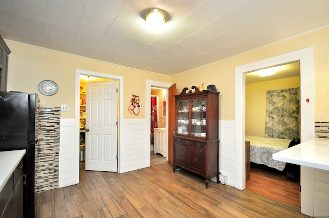 interior space with dark hardwood / wood-style flooring and black fridge