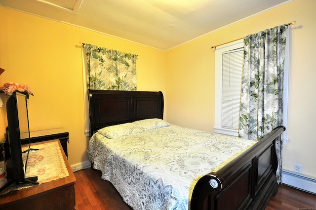 bedroom featuring dark wood-type flooring and a baseboard heating unit