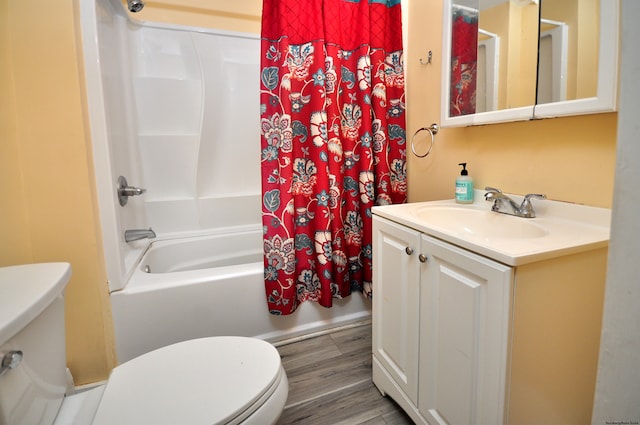 full bathroom featuring hardwood / wood-style floors, vanity, toilet, and shower / bath combo with shower curtain